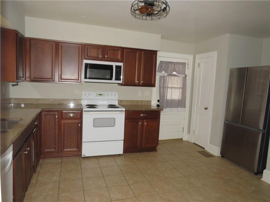 228 Marshall Street Cedartown, GA 30125 - Photo 19 of 22 a kitchen with a stove top oven and refrigerator