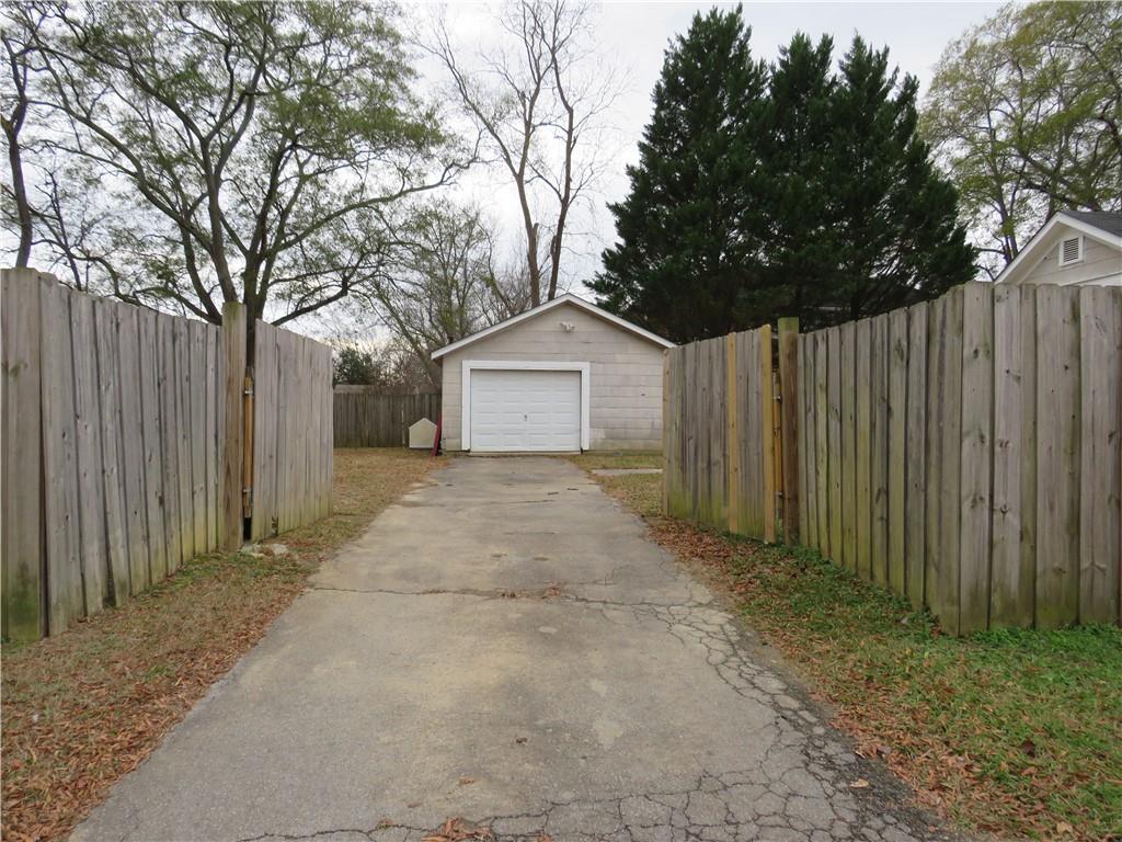 228 Marshall Street Cedartown, GA 30125 - Photo 7 of 22 a view of house with wooden fence and large trees