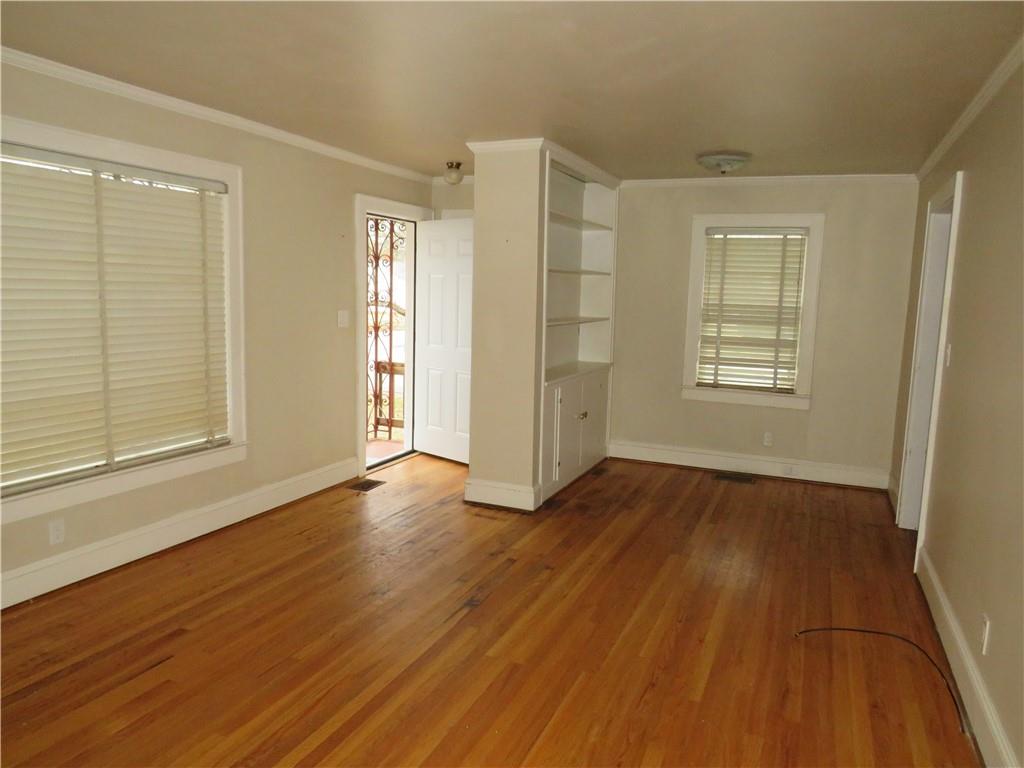 228 Marshall Street Cedartown, GA 30125 - Photo 10 of 22 a view of an empty room with wooden floor and window
