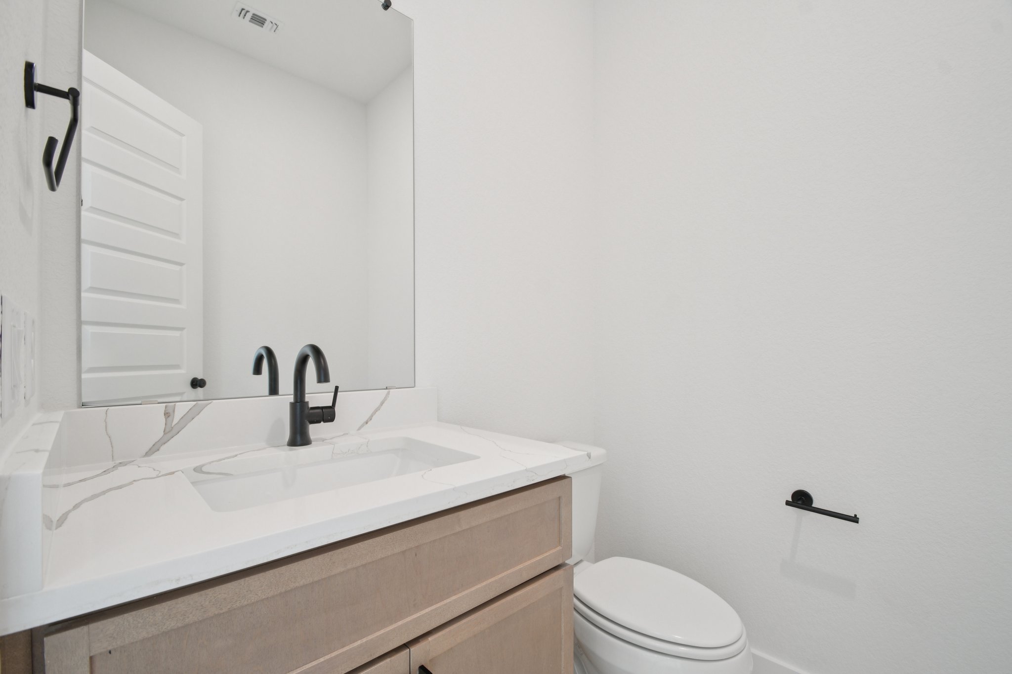 1660 Cardinal Lane Round Rock, TX 78681 - Photo 19 of 35 a bathroom with a sink a toilet and mirror