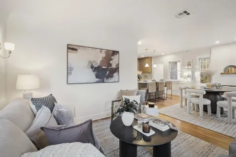 a living room with furniture and kitchen view