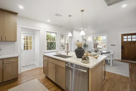 a kitchen with a sink stove and cabinets