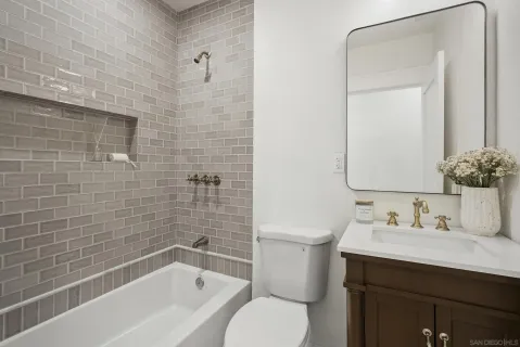 a bathroom with a sink mirror toilet and bathtub