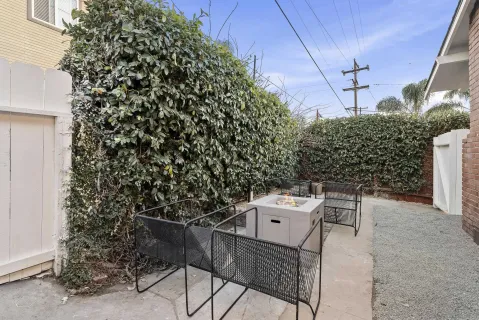 a backyard of a house with table and chairs