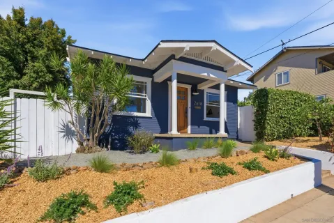 a front view of a house with garden