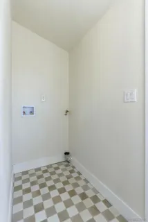 a view of a room with a white wall and a window