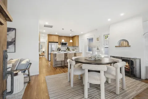 a view of a dining room with furniture and wooden floor
