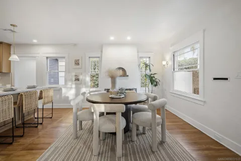 a view of a a dining room with furniture window and wooden floor