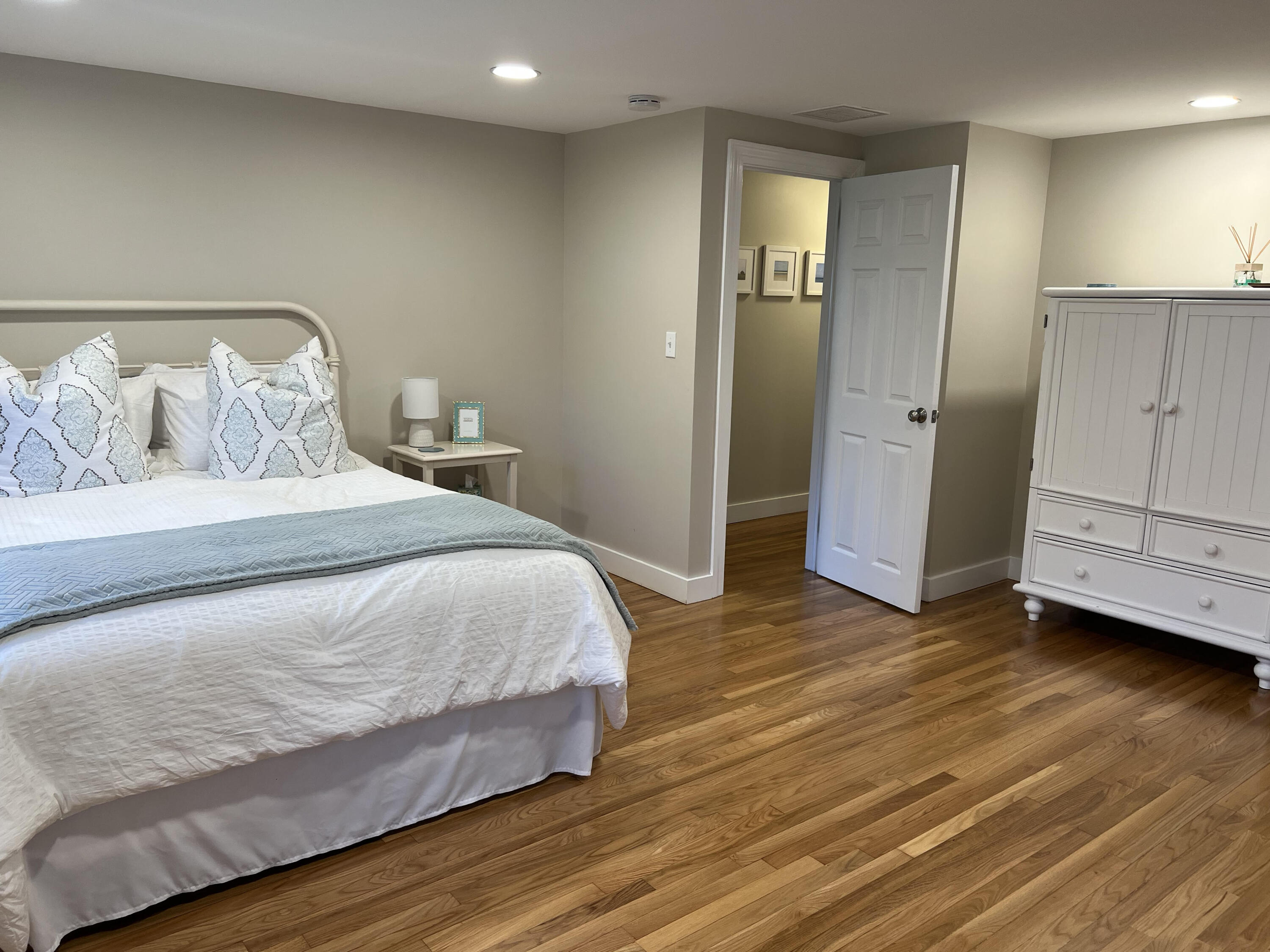 69 Joan Road Barnstable, MA 02632 - Photo 13 of 26 a bedroom with a bed and wooden floor