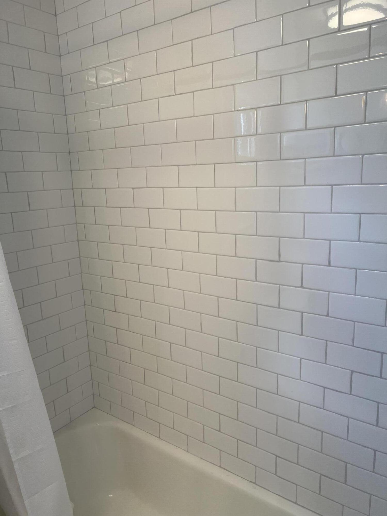 69 Joan Road Barnstable, MA 02632 - Photo 16 of 26 a bathroom with a white bathtub and a shower