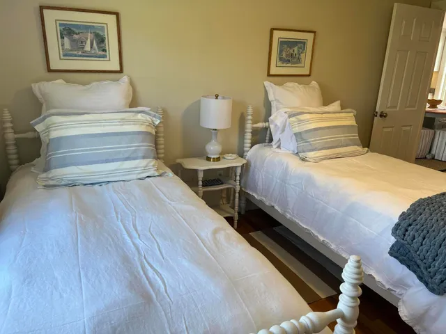 a bedroom with a bed and lamp