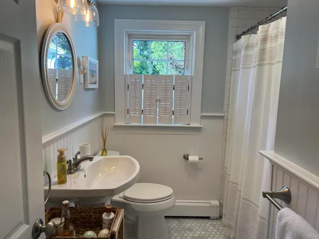 a bathroom with a sink a mirror and a toilet