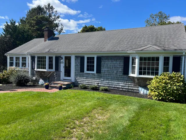 a view of a house with a yard porch and sitting area