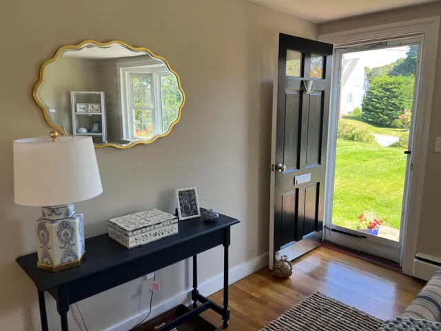 a view of a livingroom with furniture and a window