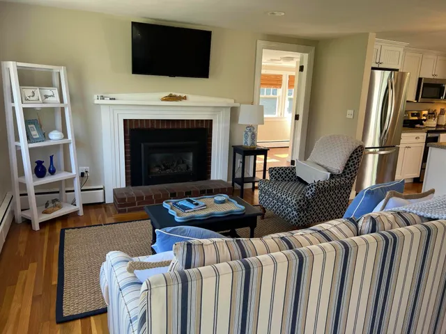 a living room with furniture fireplace and flat screen tv