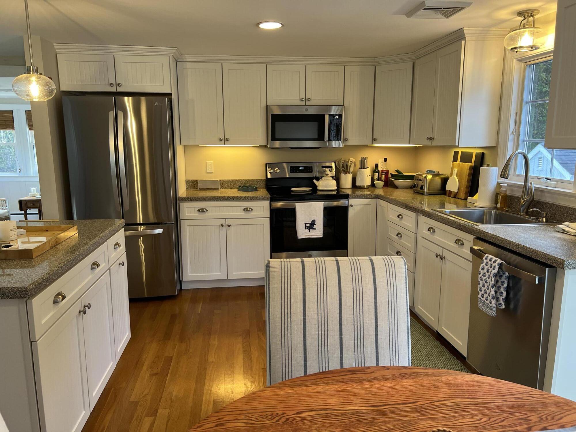 69 Joan Road Barnstable, MA 02632 - Photo 8 of 26 a kitchen with granite countertop a refrigerator stove and sink