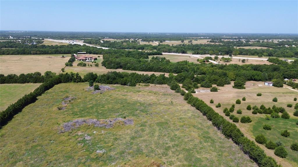 0 County Road 635 Blue Ridge, TX 75424 - Photo 7 of 8 Expansive land parcel featuring open fields, natural tree lines, and a distant developed area