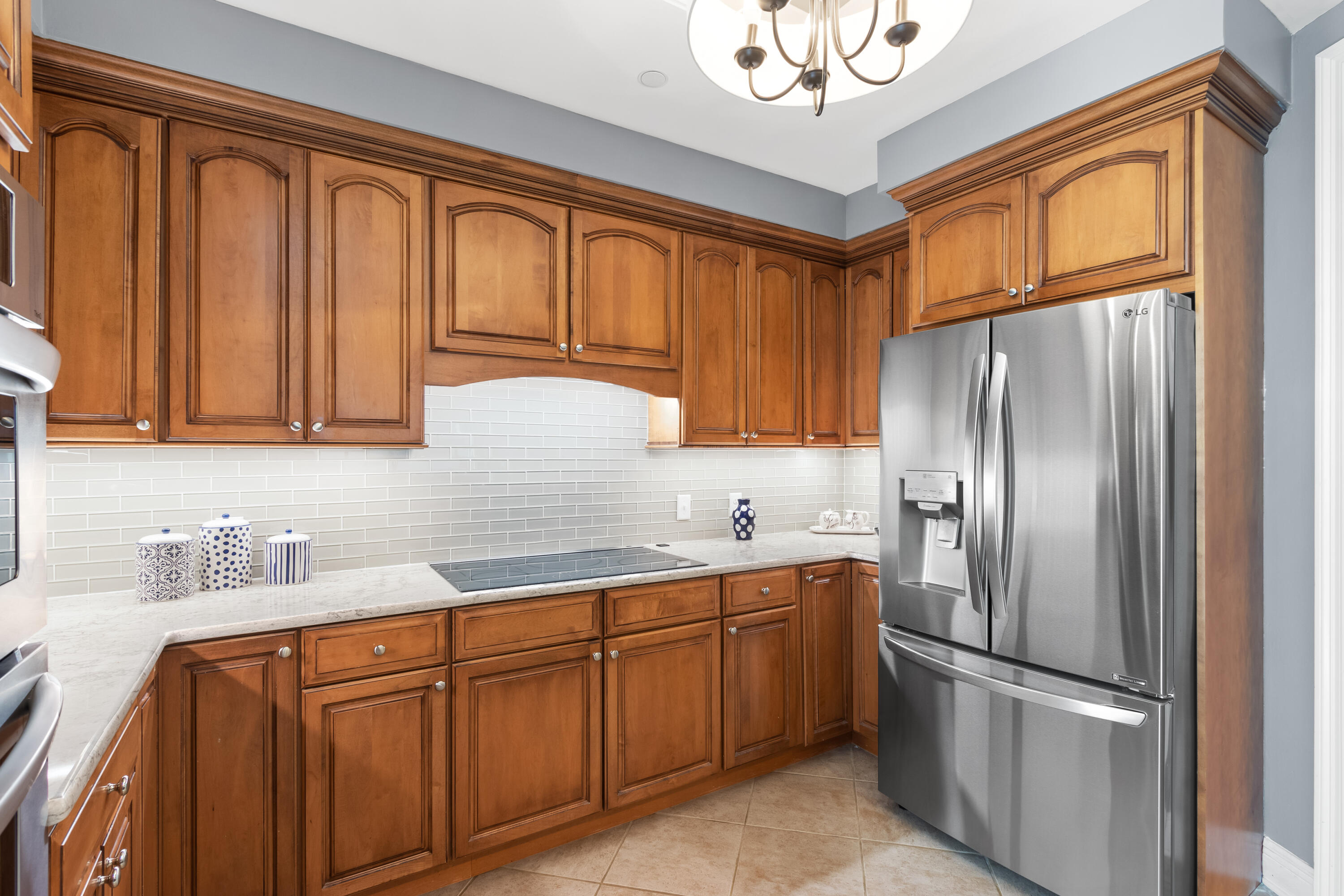 1044 Highway 98, Unit PH1403 Destin, FL 32541 - Photo 18 of 49 a kitchen with stainless steel appliances granite countertop a refrigerator sink and cabinets