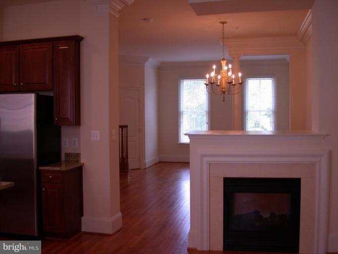1730 Carpenter Road Alexandria, VA 22314 - Photo 16 of 20 a view of a livingroom with a fireplace wooden floor and a kitchen