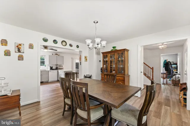 a living room with furniture and a dining table