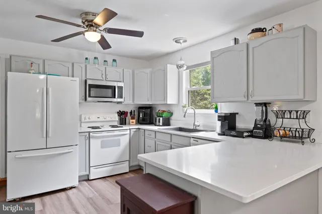 an aerial view of a residential houses with outdoor space and swimming pool