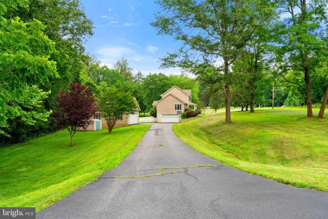 a view of a hallway with wooden floor and stairs