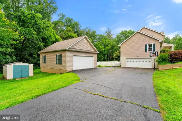 a kitchen with stainless steel appliances kitchen island granite countertop a refrigerator and a dining table