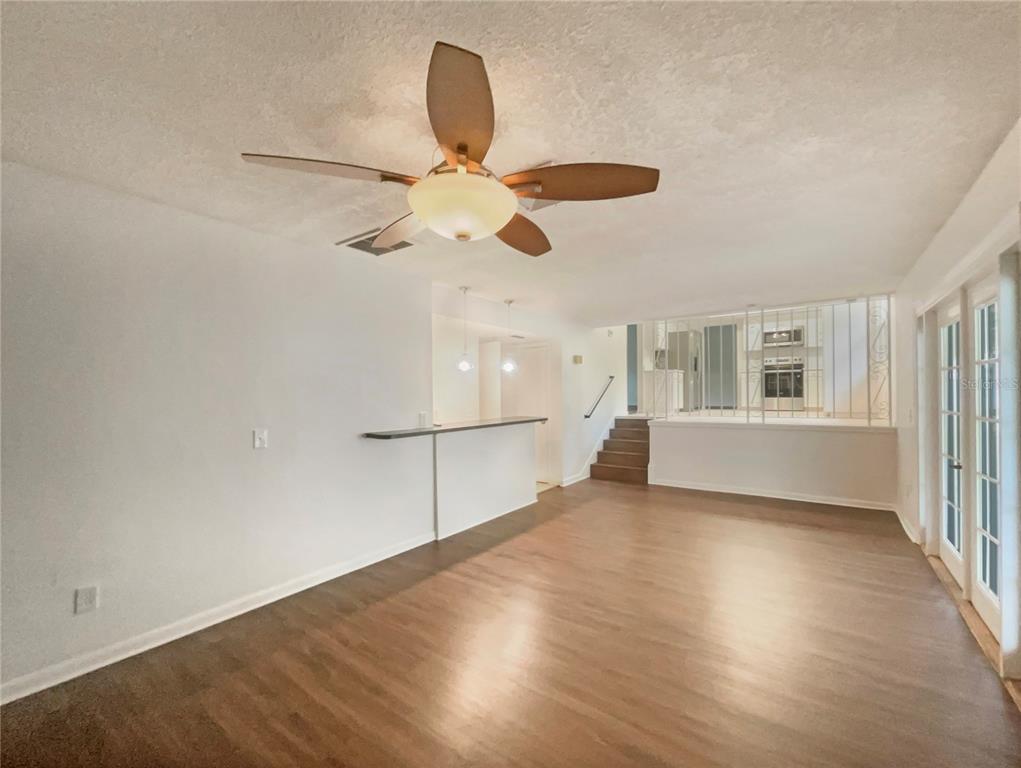 1911 Rambling Lane Brandon, FL 33510 - Photo 13 of 29 a view of an empty room with a window and wooden floor