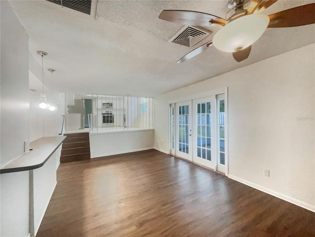 1911 Rambling Lane Brandon, FL 33510 - Photo 14 of 29 a view of an empty room with wooden floor and a window