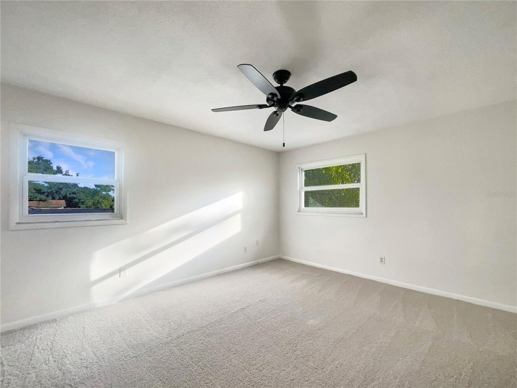 1911 Rambling Lane Brandon, FL 33510 - Photo 17 of 29 an empty room with a window and a ceiling fan