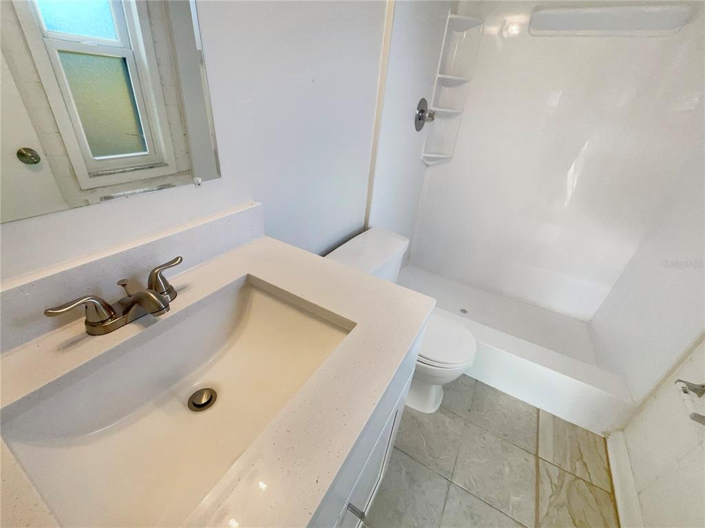 1911 Rambling Lane Brandon, FL 33510 - Photo 20 of 29 a bathroom with a tub sink and mirror
