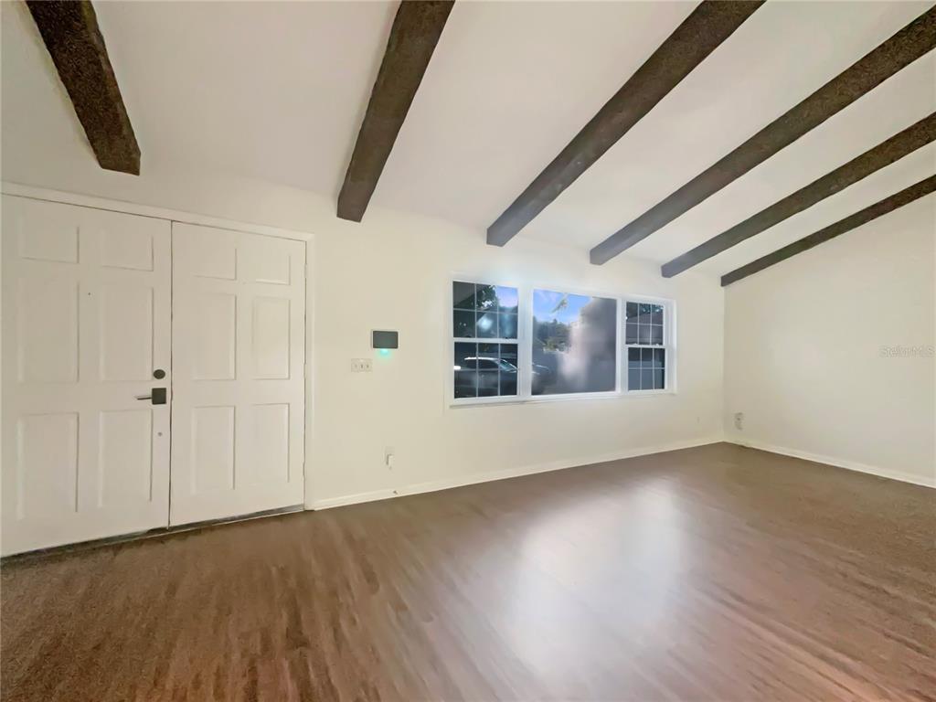1911 Rambling Lane Brandon, FL 33510 - Photo 5 of 29 a view of an empty room with wooden floor and a window