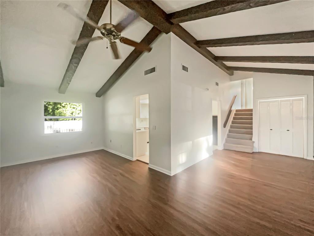 1911 Rambling Lane Brandon, FL 33510 - Photo 6 of 29 a view of an empty room with wooden floor and stairs
