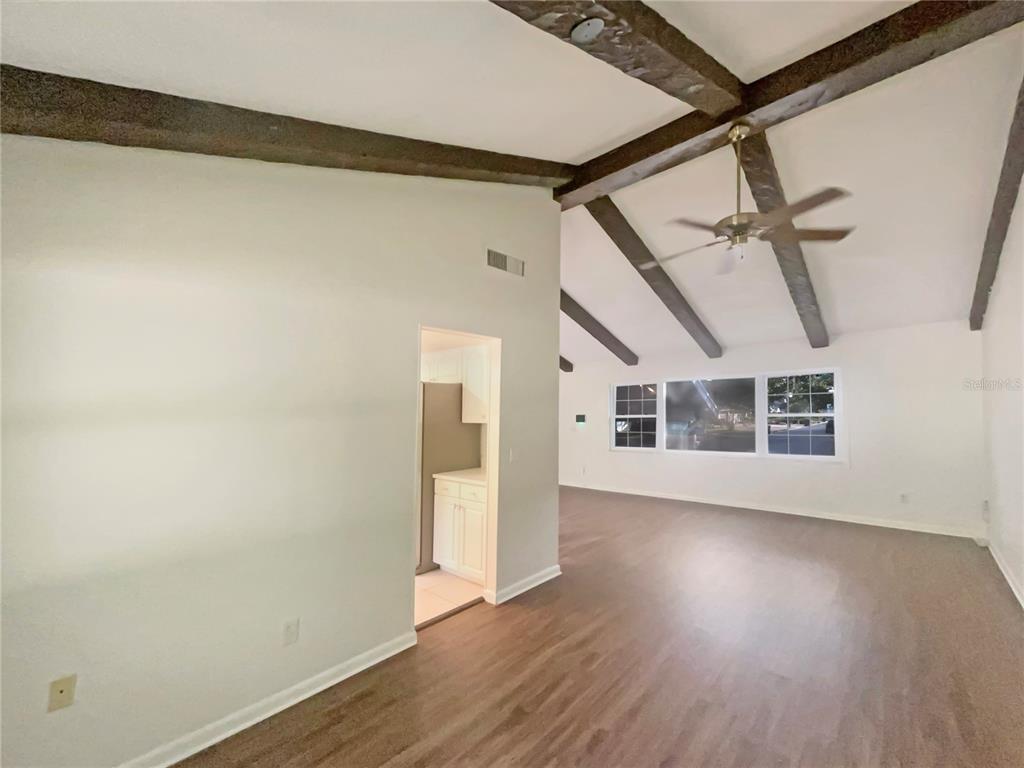 1911 Rambling Lane Brandon, FL 33510 - Photo 7 of 29 a view of an empty room with wooden floor and a window