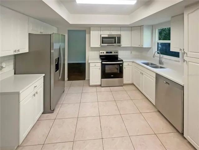 a kitchen with a sink a stove and refrigerator