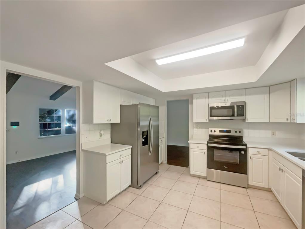 1911 Rambling Lane Brandon, FL 33510 - Photo 9 of 29 a kitchen with stainless steel appliances and white cabinets