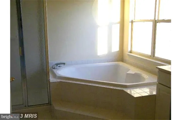 a bath tub sitting next to a window
