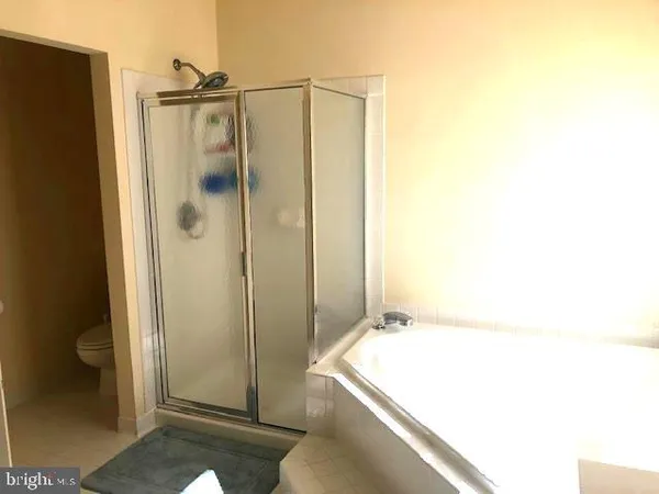 a bathroom with a tub and shower