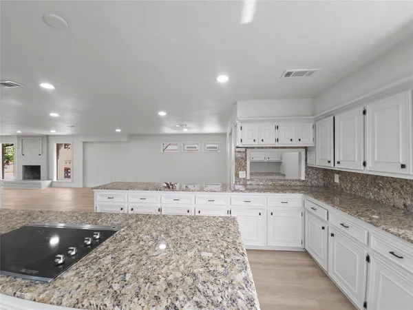 a kitchen with a sink stove and cabinets