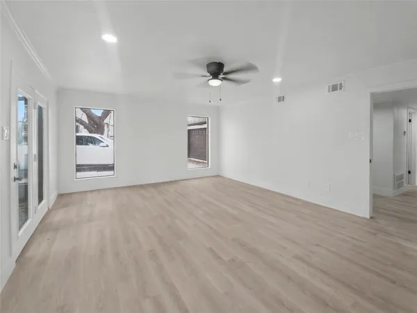 wooden floor in an empty room with a window