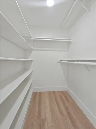 a bathroom with a granite countertop sink a mirror and shower