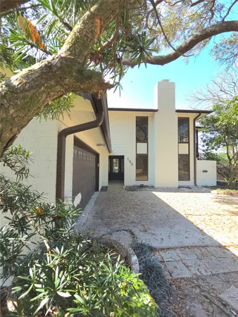a view of a house with a yard and tree