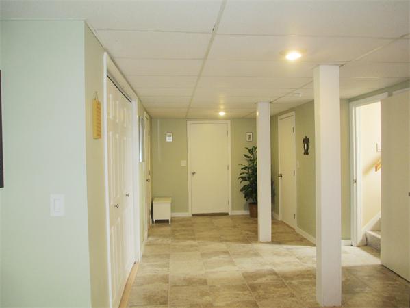 22 Rickey Drive Maynard, MA 01754 - Photo 12 of 16 a view of a hallway with wooden shelves
