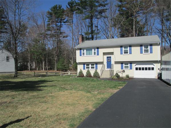22 Rickey Drive Maynard, MA 01754 - Photo 16 of 16 a view of a house with a yard and large trees