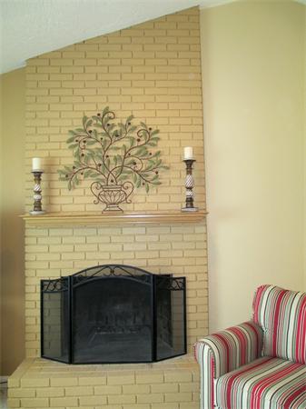 22 Rickey Drive Maynard, MA 01754 - Photo 4 of 16 a living room with a fireplace and a wooden floor