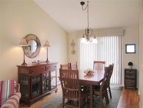 22 Rickey Drive Maynard, MA 01754 - Photo 5 of 16 a dining room with furniture a chandelier and wooden floor
