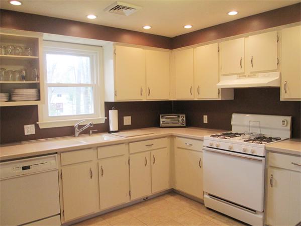 22 Rickey Drive Maynard, MA 01754 - Photo 7 of 16 a kitchen with white cabinets and sink