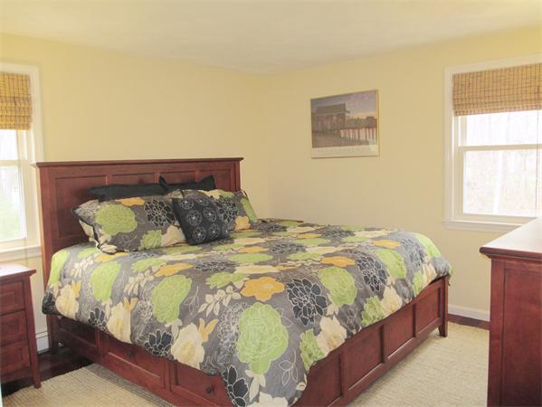 22 Rickey Drive Maynard, MA 01754 - Photo 8 of 16 a bed sitting in a bedroom next to a window