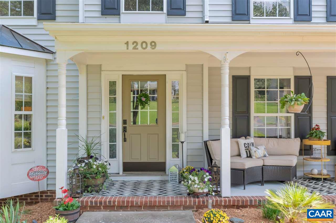 1209 Raintree Drive Charlottesville, VA 22901 - Photo 1 of 46 a front view of a house with a garden