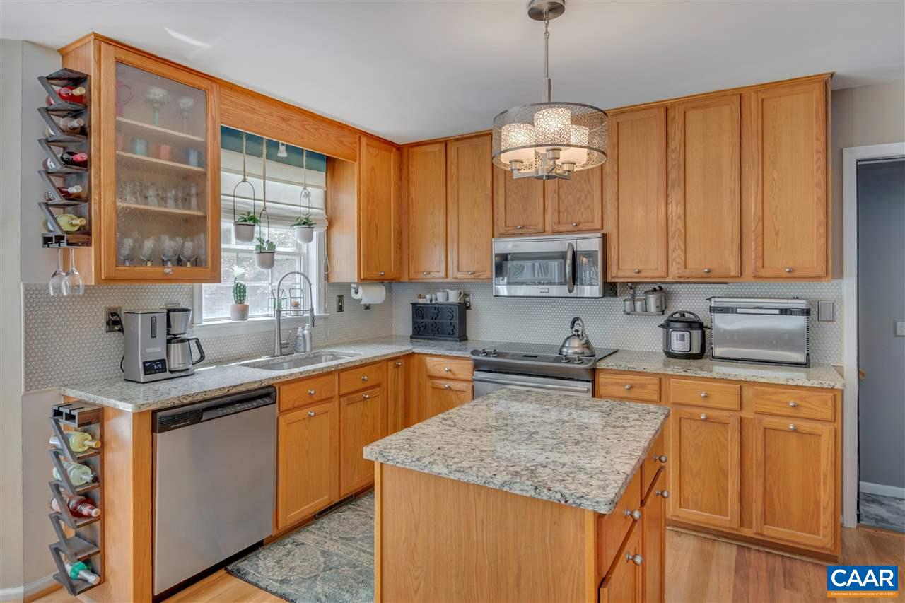 1209 Raintree Drive Charlottesville, VA 22901 - Photo 20 of 46 a kitchen with stainless steel appliances granite countertop a sink stove and microwave
